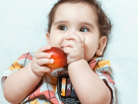 Toddler eating a nectarine
